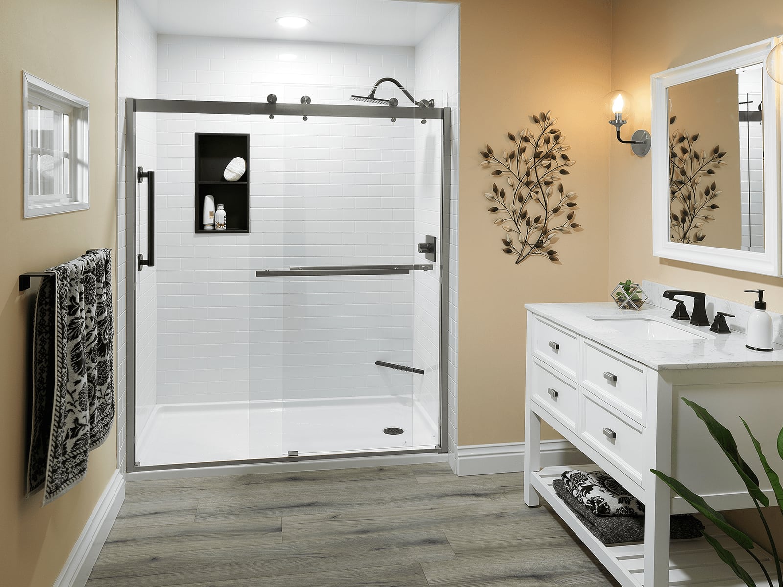 Glass-enclosed walk-in shower beside a vanity